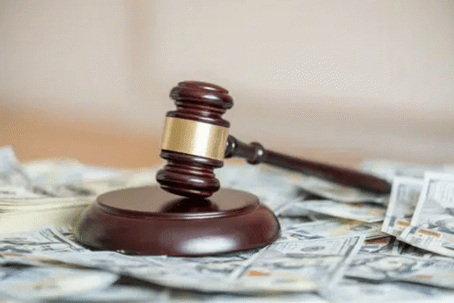 gavel on top of money