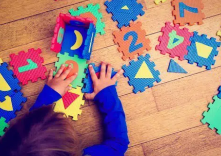 Young kid playing with a puzzle