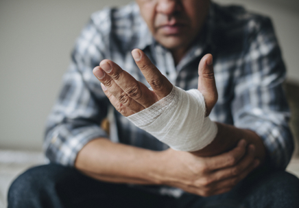 Man with a gauze bandage wrapped around his hand